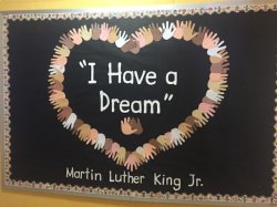 Childrens hands making a heart that says Martin Luther King Day