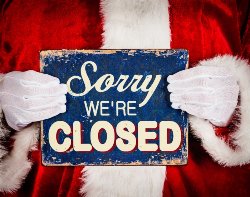 Santa holding closed sign 